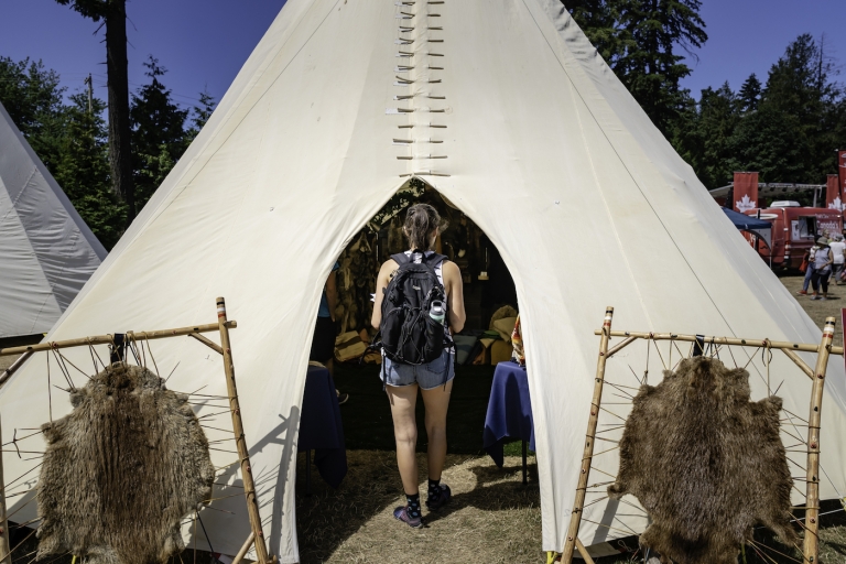 Woman walks into teepee